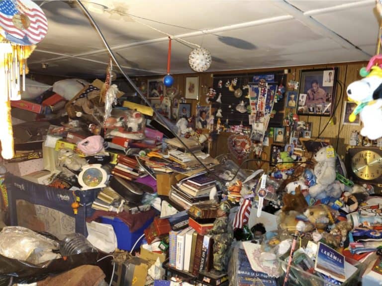basement filled with items with fire and smoke damage.